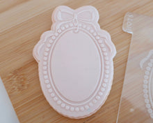 Load image into Gallery viewer, Pearl Frame with Bow Fondant Embosser / Cutter - Made in the UK with Love from House of Toot Sweet - Just £6.50! Shop now at House of Toot Sweet